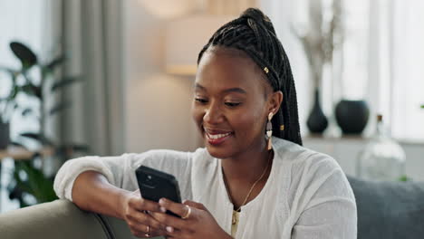 Happy,-funny-and-black-woman-on-a-couch