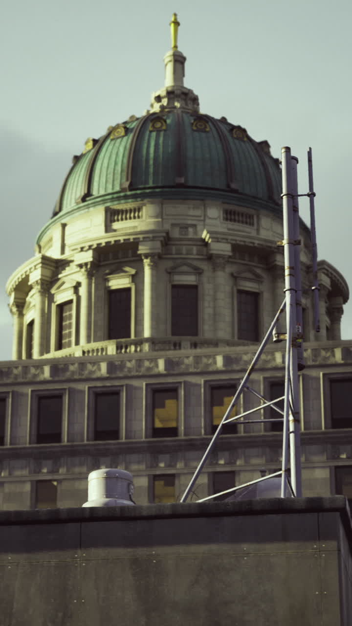 Historic building dome shines under cloudy sky in urban setting