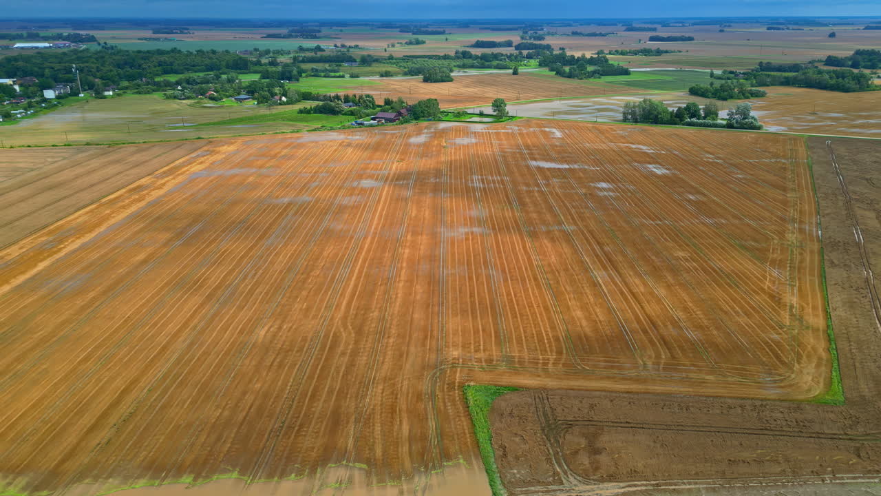 AERIAL: Sunlight and shadows moving over flooded fields, aftermath of heavy rain