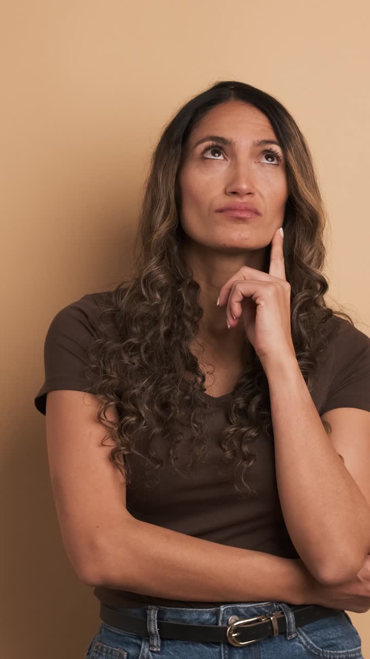 Pensive hispanic woman unsure about a decision. Vertical Footage
