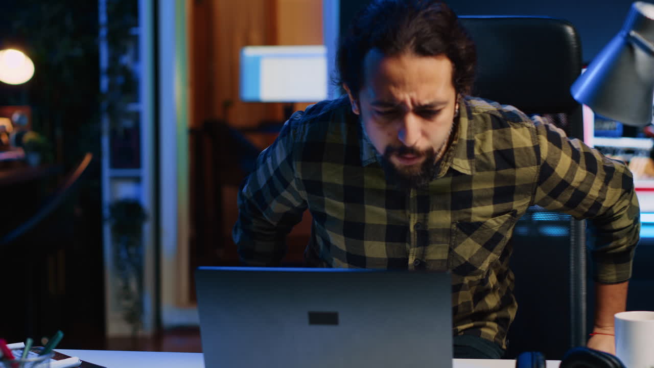 Entrepreneur starting his day working from home, opening laptop