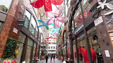 vibrant pinwheel decorations adorn a busy shopping street