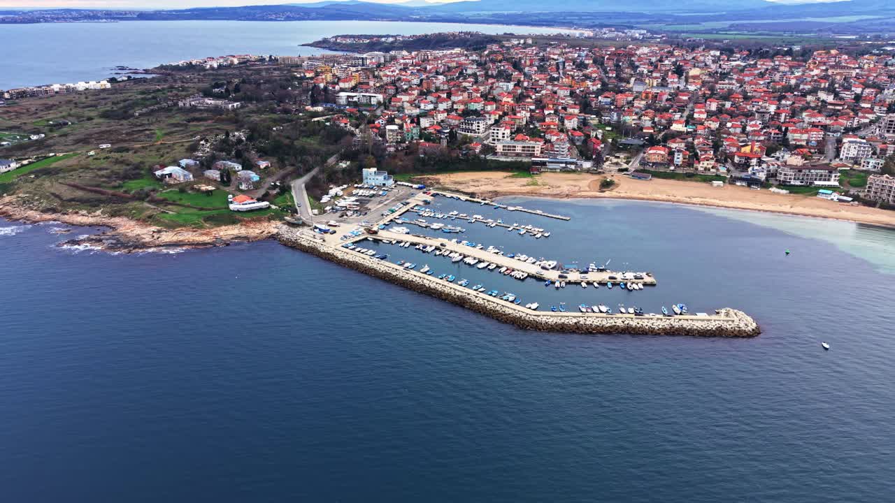 Coastal town viewed from above showcasing marina and residential areas