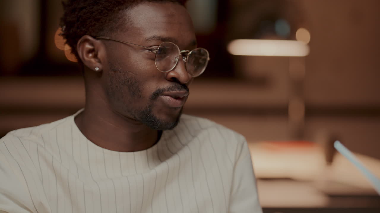 Young African American Man Talking to Colleagues at Office Meeting