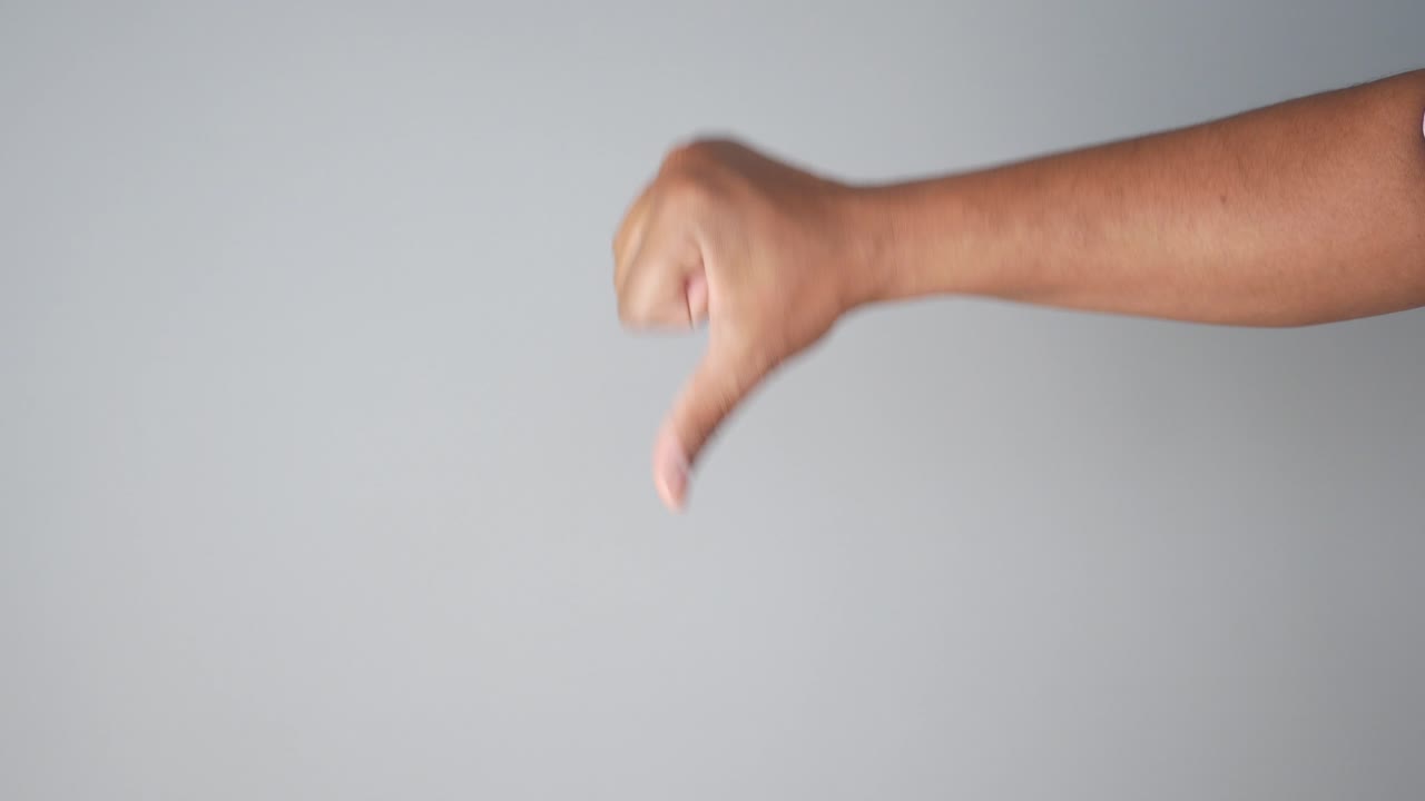 엄지손가락을 내려놓는 몸짓을 하는 손