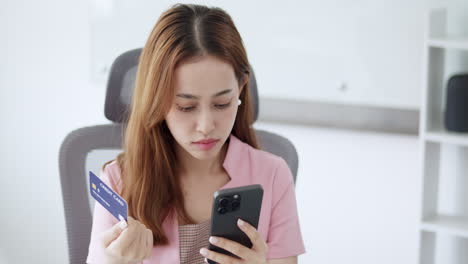 woman making online payment using credit card and smartphone