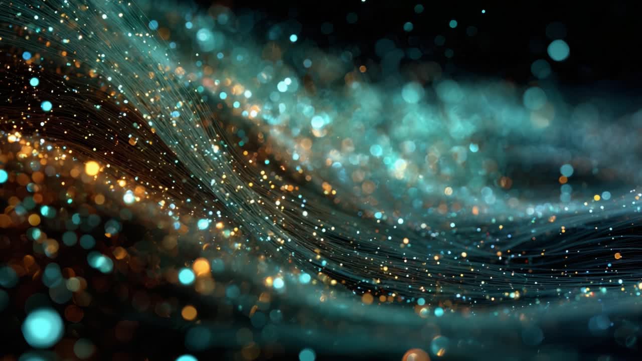 Abstract motion background showing teal and gold glowing particles flowing along wavy lines, creating a beautiful bokeh effect representing digital data streams, technology, or space phenomena