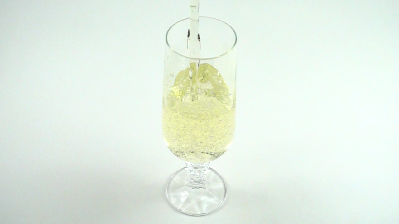 Champagne versato in un bicchiere. Movimento rallentato