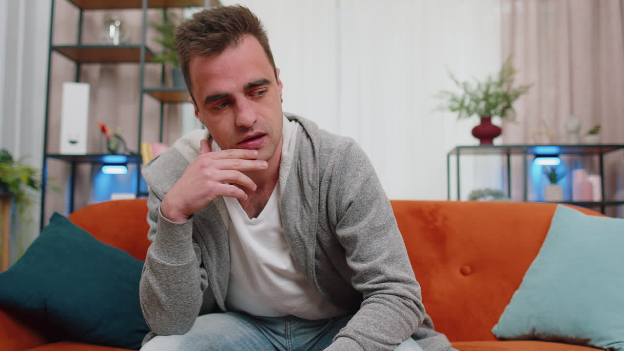 un joven en casa sufre de una situación injusta problema, ruptura, depresión, sentirse mal, agotamiento