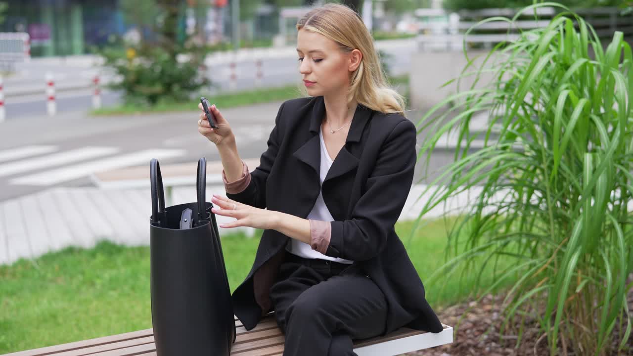 Businesswoman using a smartphone outdoors
