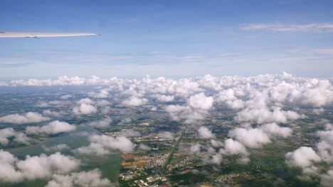 a view of the upper plane window while floating in the air, overlooking the mountains and natural water resources along the coast of thailand