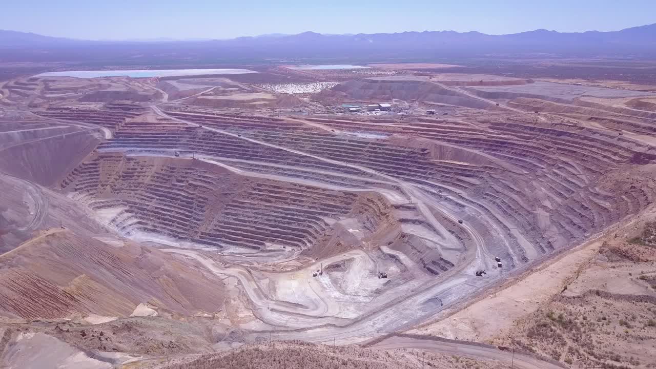 An aerial over a vast open pit strip mine in the Arizona desert 5