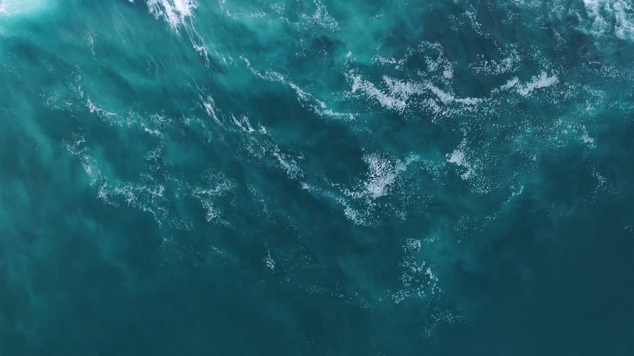 Top Down Drone Video of Turquoise Waves and Abstract Patterns in Ocean of Uluwatu, Bali Indonesia
