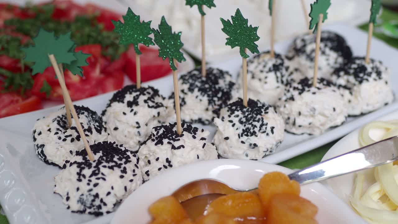 Cheese Balls with Sesame Seeds and Green Leaves