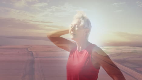 animation of glowing light over portrait of happy senior woman