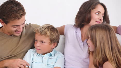 family on couch chatting happily