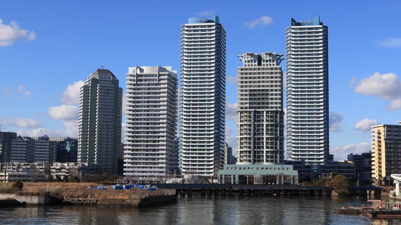 Apartment in front of the waterfront during the day on the sunny day.