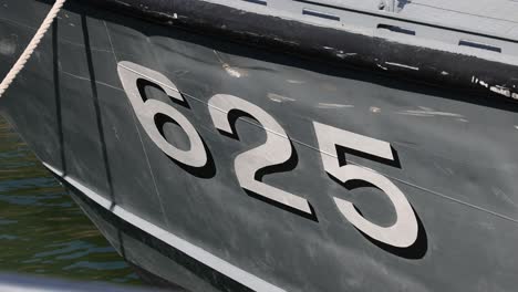 number 625 on a grey ship hull