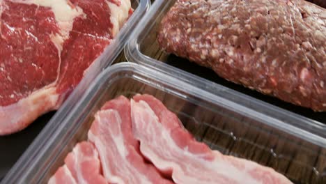 varieties of meat in plastic boxes