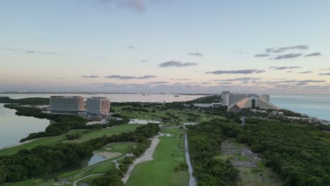 cancun's lush golf course with resort buildings by the coast, aerial view, playa delfines