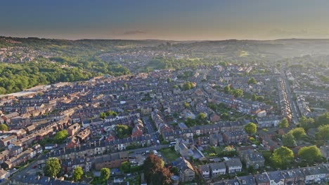 City-â€‹â€‹bus-driving-in-a-densely-populated-residential-area-in-Hillsborough-park-during-the-setting-sun-in-Sheffield