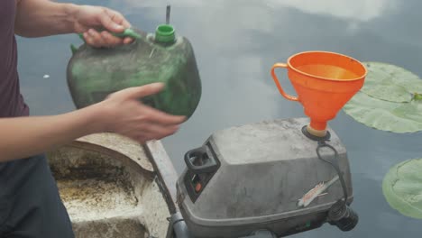 filling up a two-stroke outboard engine with petrol