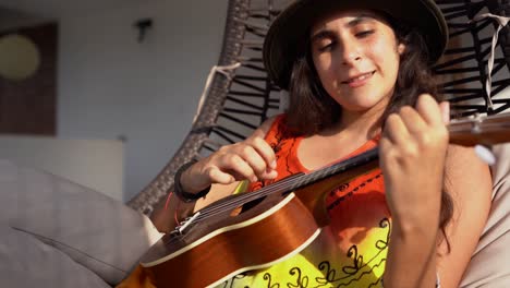 girl playing ukulele guitar on a sunny day outside