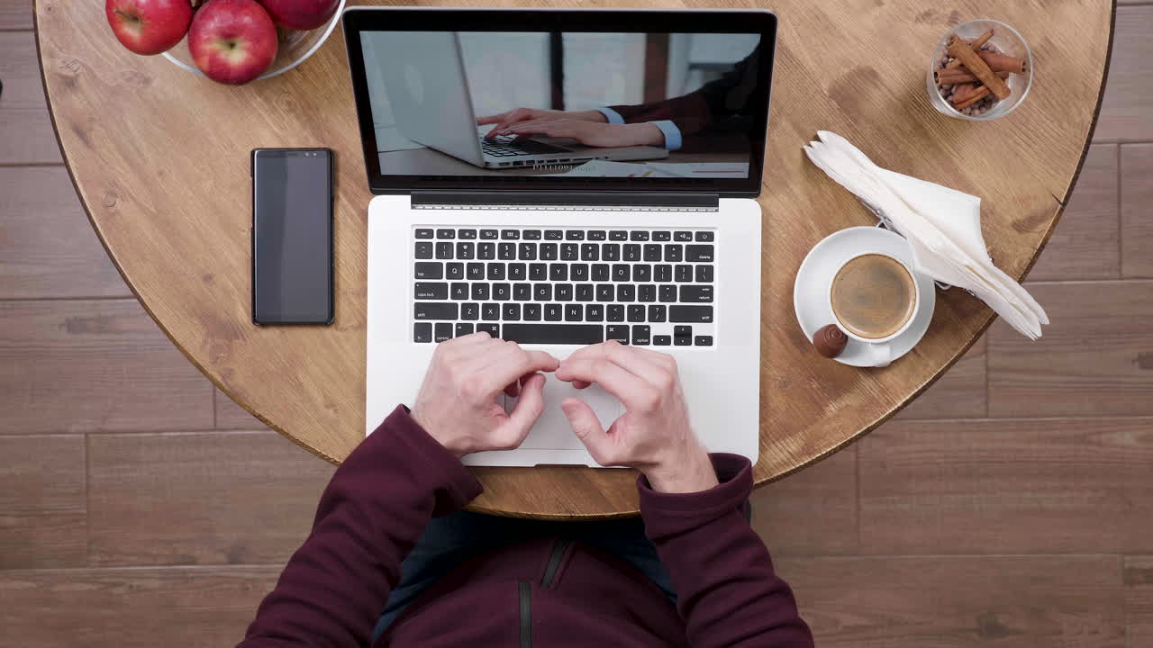 Workspace with laptop, coffee, and smartphone