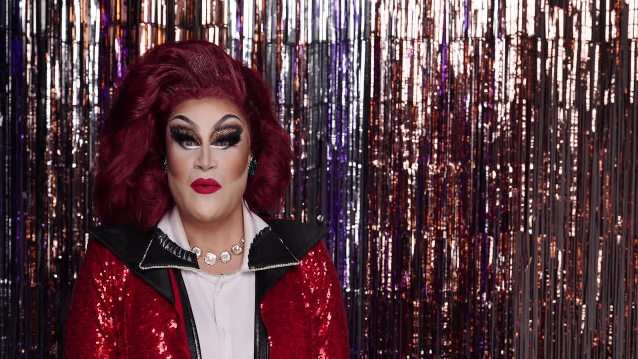 Drag Queen Pointing with Sequin Jacket and Red Hair