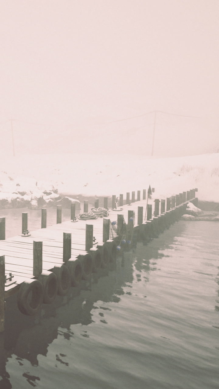 Snowy dock with mist over water in a cold winter scene