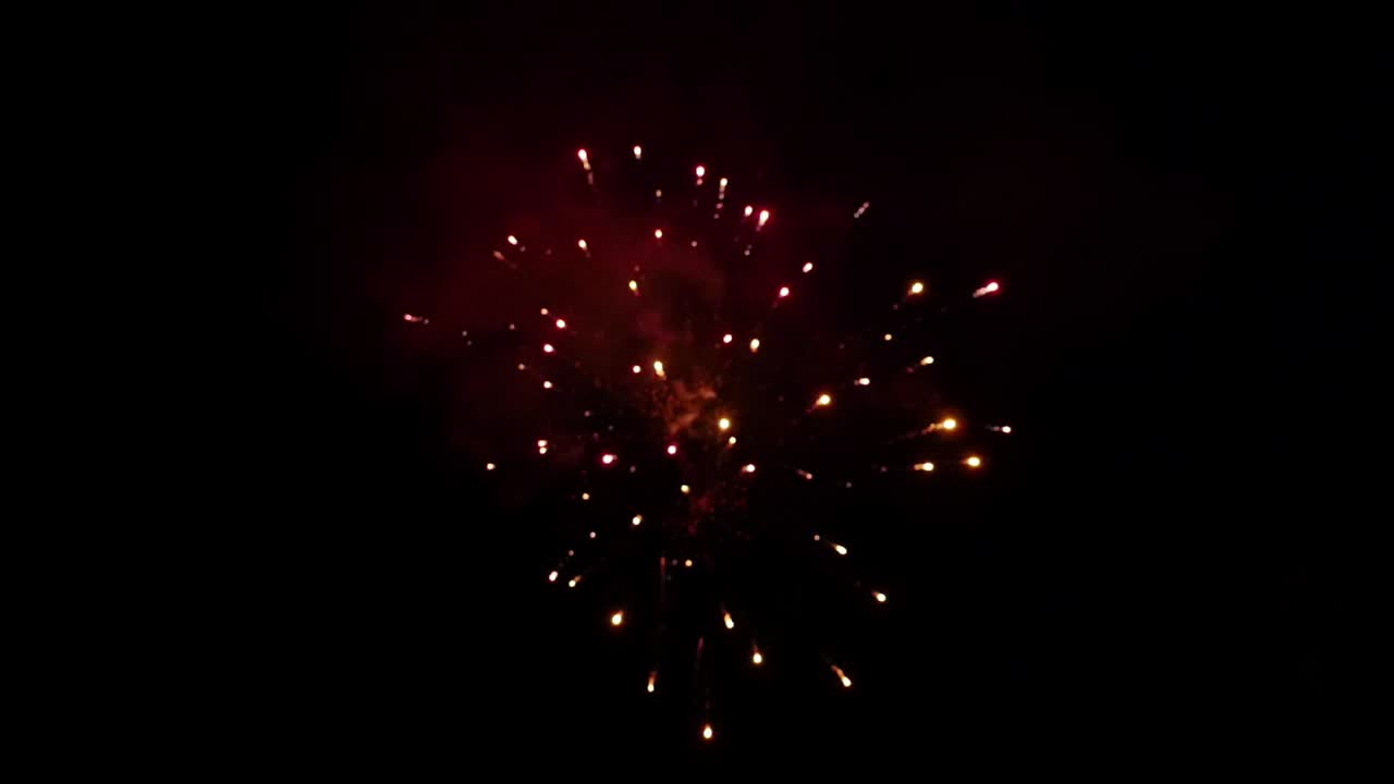 Fireworks display on dark night sky in slow motion blur
