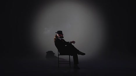 dramatic portrait of a man smoking in a spotlight