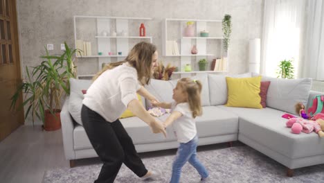 Mom-and-daughter-are-dancing-and-having-fun-at-home.
