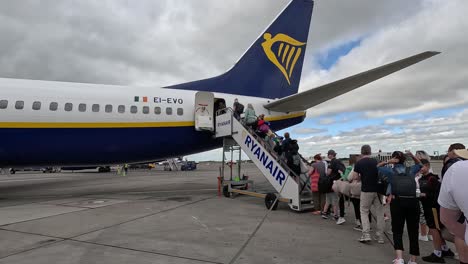 travelers boarding the plane to embark on their dream vacations from dublin, ireland - medium shot