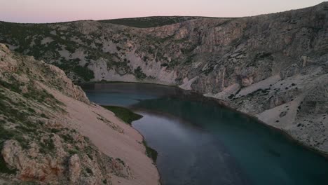 the rocky canyon walls which flank the zrmanja river rush by as this drone shot approaches the water