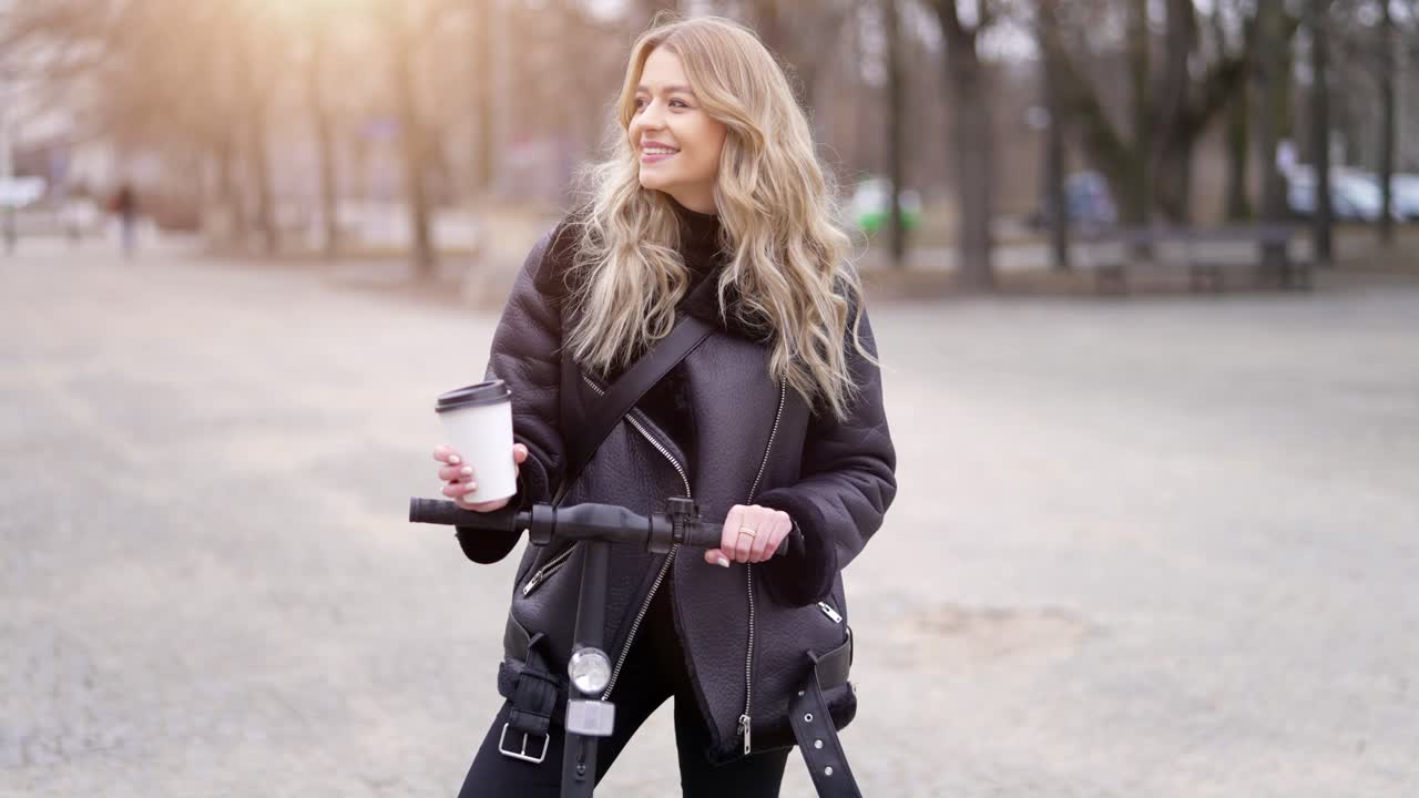 Woman enjoying coffee break on electric scooter