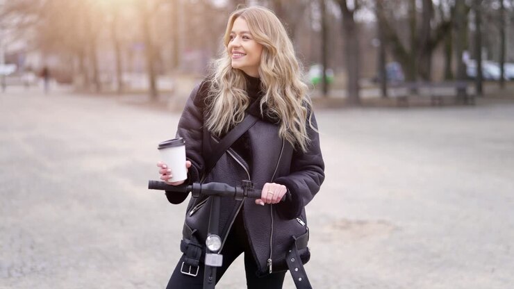 frau genießt eine kaffeepause auf einem elektrischen roller