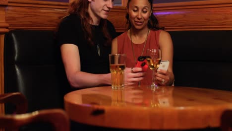 couple using mobile phone in night club 4k