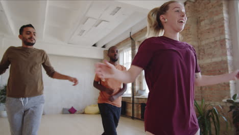 multiethnic men having dance class with female teacher