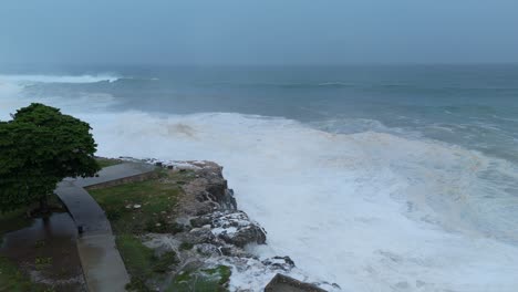 waves of caribbean sea flooding coastline and city of dominican republic