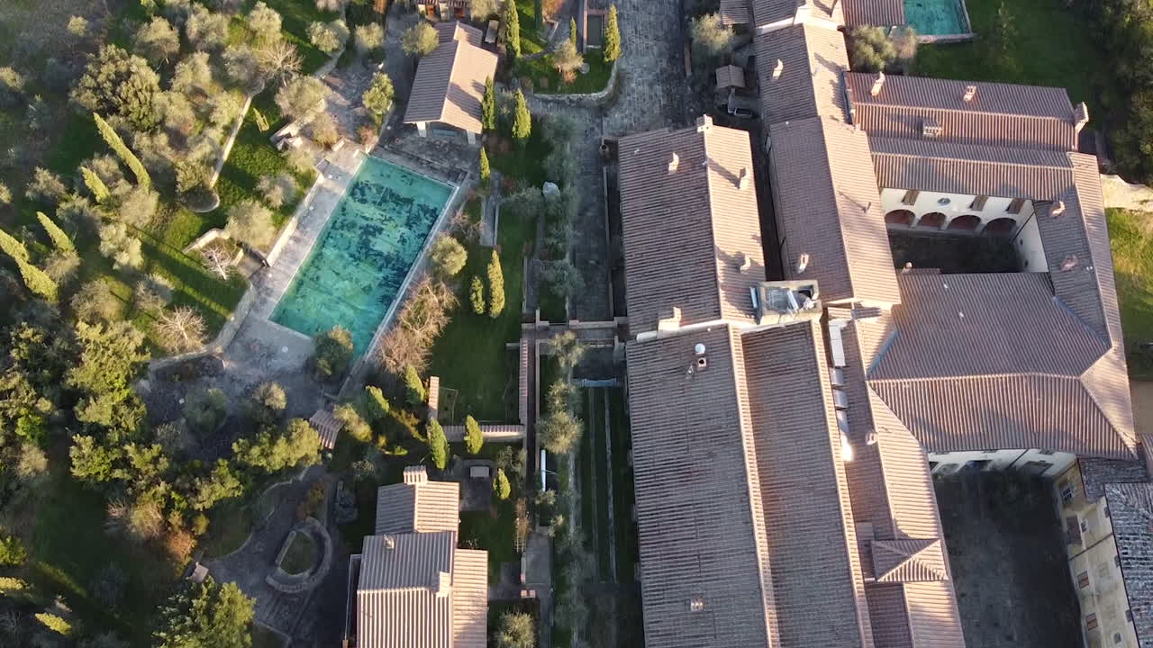 Flying over aerial CasaMora 18th century agriturismo and homestead in the amazing Florence surrounding hills. Winter season at sunset, Piandisco Arezzo , Tuscany Italy