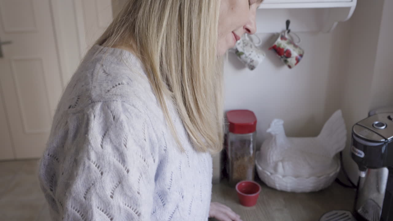 Woman in kitchen preparing coffee