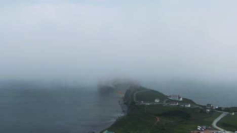 Stunning-View-Of-Perce-Rock-Behind-Clouds-In-The-Gulf-Of-Saint-Lawrence,-Quebec,-Canada---aerial-drone