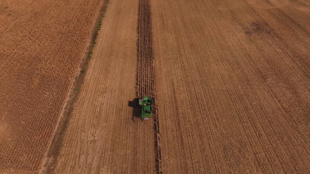 Grain harvest and tractor in Steti's fields, Czech Republic aerial view