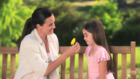 mother and daughter with a flower