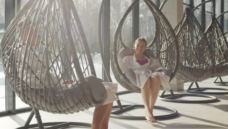 couple relaxing in hanging chairs at a spa