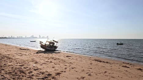 a boat rests on a sunny beach