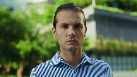 portrait of a man in a striped shirt outdoors