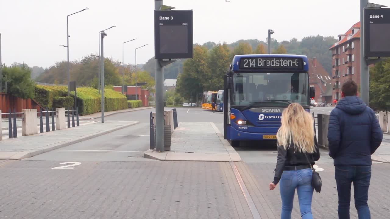 People walking toward the bus  in Vejle Central bus station, Denmark.