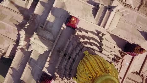 a breathtaking birdseye aerial view of the white temple in myanmar, formerly burma. captures the intricate architecture of this iconic landmark surrounded by lush greenery.